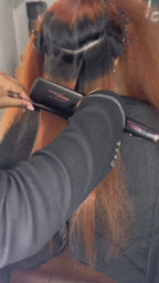 Stylist using Amour Thairapy 2-inch Titanium Flat Iron on hair.